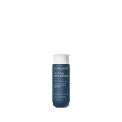 A bottle of Clarifying Detox Shampoo with a dark blue body, white cap, and white front text stands upright against a plain background. This shampoo removes buildup from hard water.